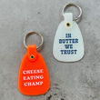 Load image into Gallery viewer, In Butter We Trust Saddle Keychain - Glow In the Dark